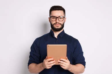 Photo of Handsome man using tablet on white background