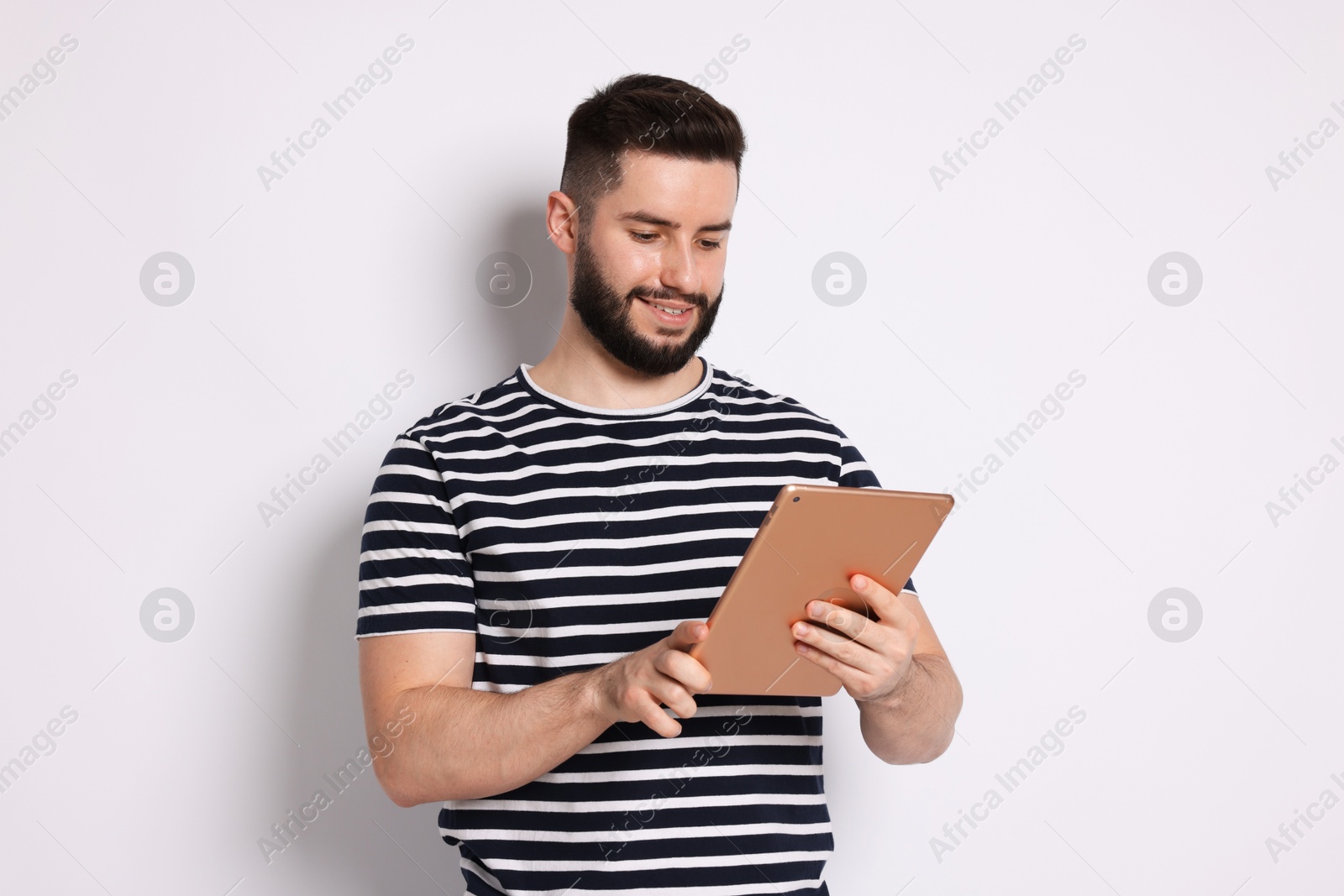Handsome man using tablet on white background Photo of Handsome man using tablet on white background