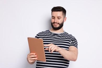 Photo of Handsome man using tablet on white background