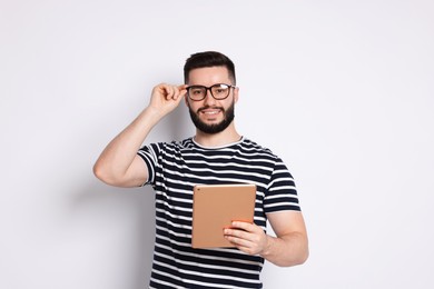 Photo of Handsome man using tablet on white background