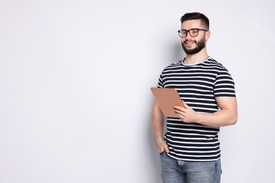 Photo of Handsome man using tablet on white background, space for text