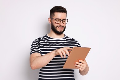 Photo of Handsome man using tablet on white background