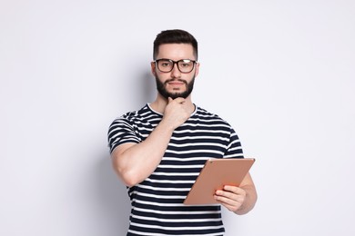 Photo of Handsome man using tablet on white background