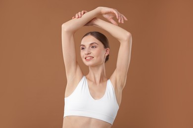 Photo of Portrait of beautiful young woman on beige background