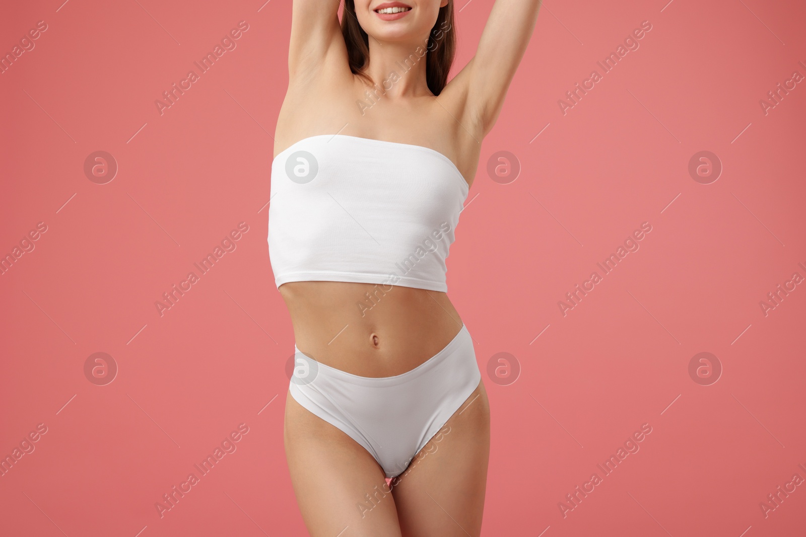 Woman with perfect slim body on pink background, closeup Photo of Woman with perfect slim body on pink background, closeup