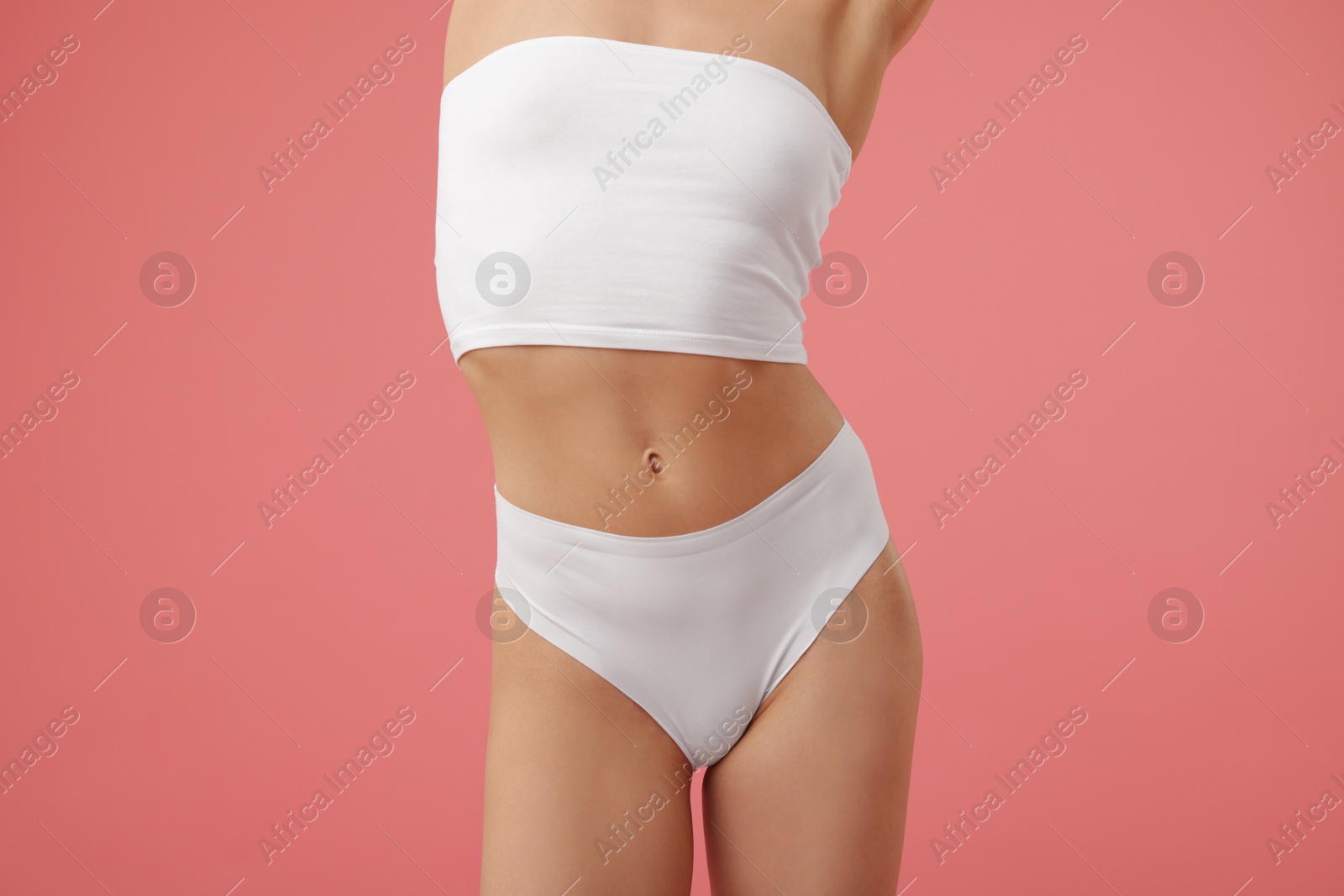 Woman with perfect slim body on pink background, closeup Photo of Woman with perfect slim body on pink background, closeup