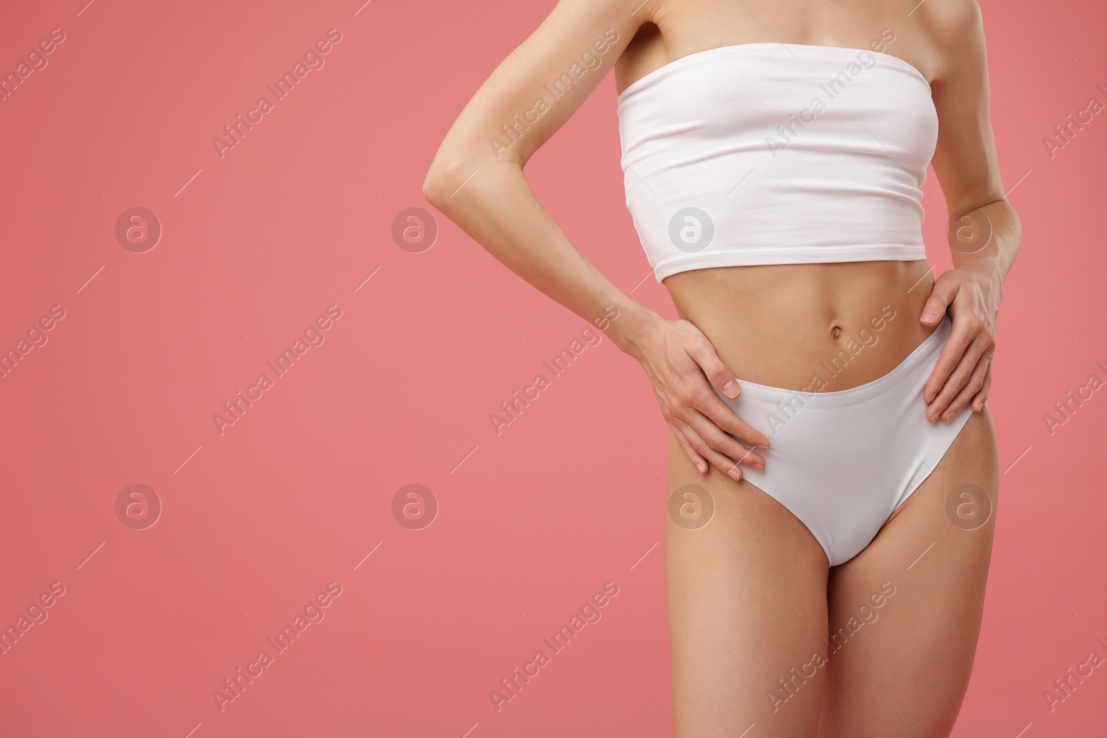 Woman with perfect slim body on pink background, closeup. Space for text Photo of Woman with perfect slim body on pink background, closeup. Space for text