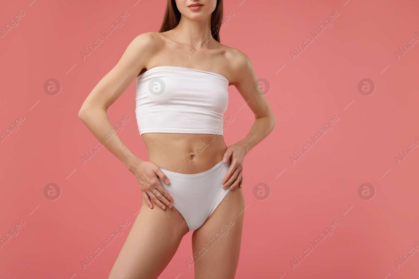 Woman with perfect slim body on pink background, closeup Photo of Woman with perfect slim body on pink background, closeup