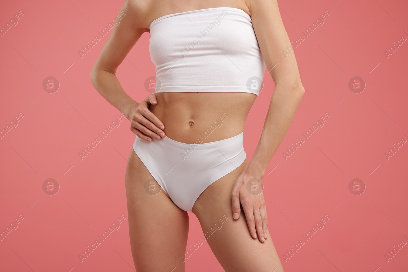 Woman with perfect slim body on pink background, closeup Photo of Woman with perfect slim body on pink background, closeup