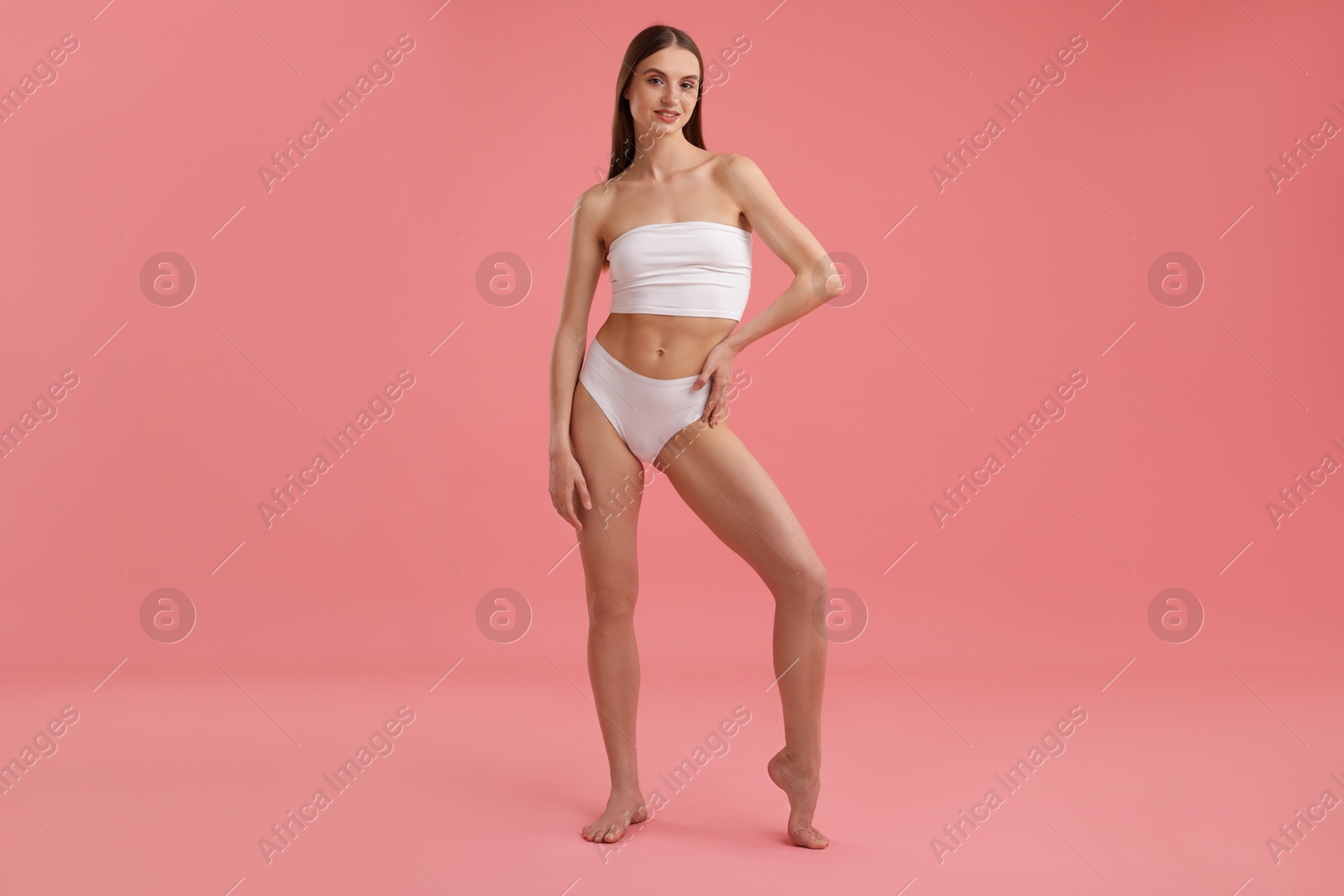 Beautiful woman with perfect slim body on pink background Photo of Beautiful woman with perfect slim body on pink background