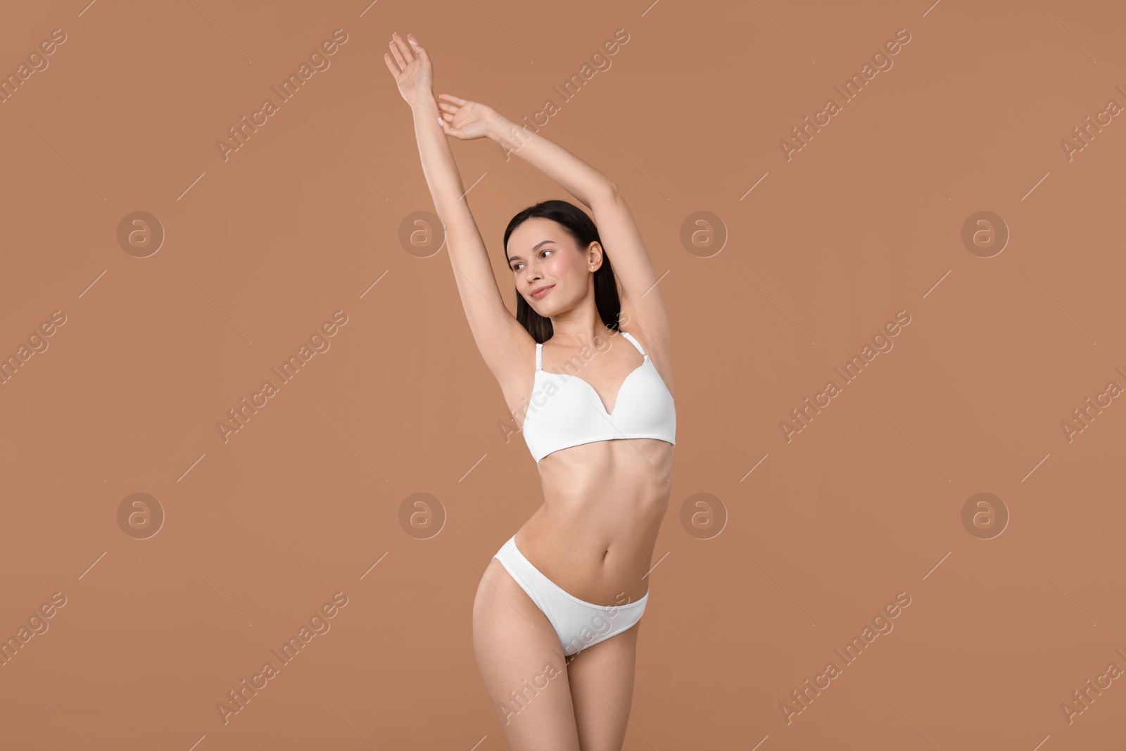 Woman with perfect slim body on beige background Photo of Woman with perfect slim body on beige background