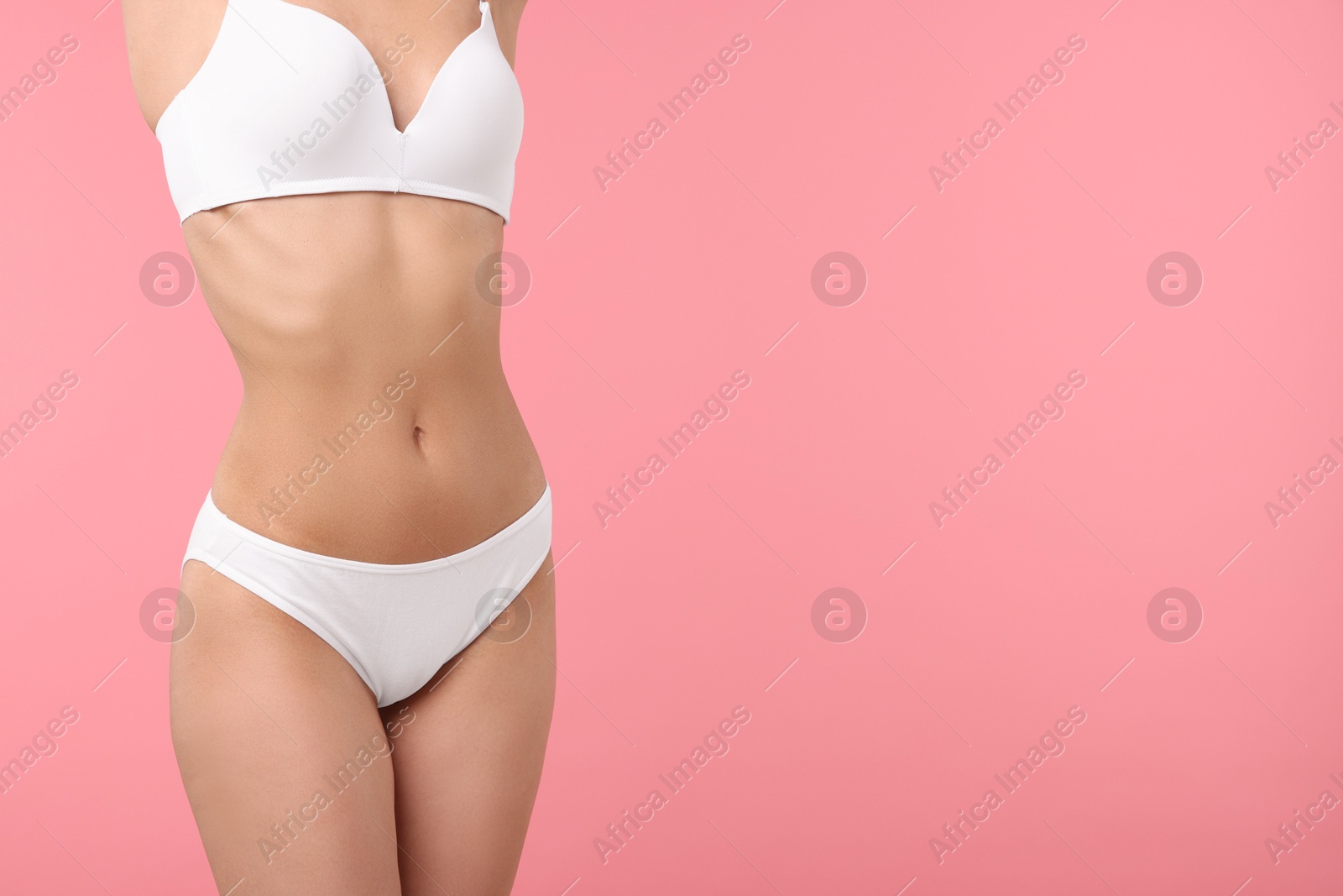 Woman with perfect slim body on pink background, closeup. Space for text Photo of Woman with perfect slim body on pink background, closeup. Space for text