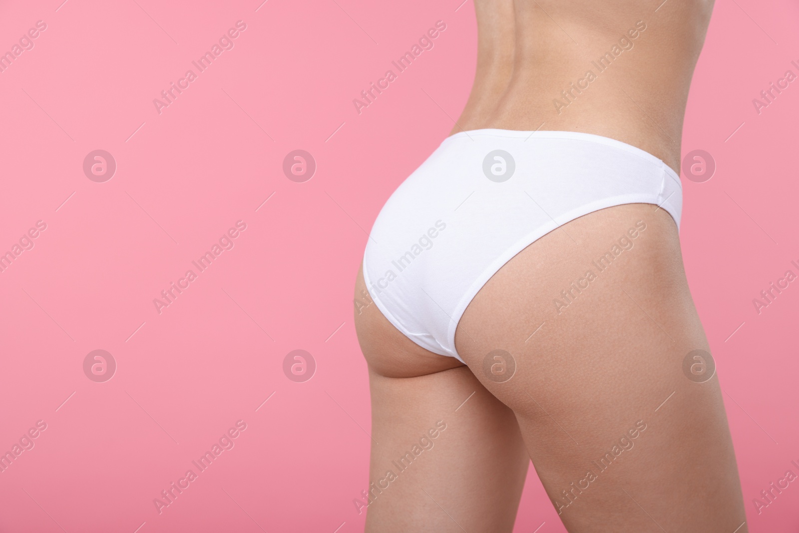 Woman with perfect slim body on pink background, closeup. Space for text Photo of Woman with perfect slim body on pink background, closeup. Space for text