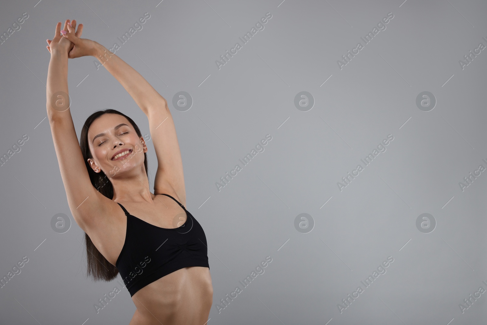 Portrait of beautiful young woman on gray background, space for text Photo of Portrait of beautiful young woman on gray background, space for text