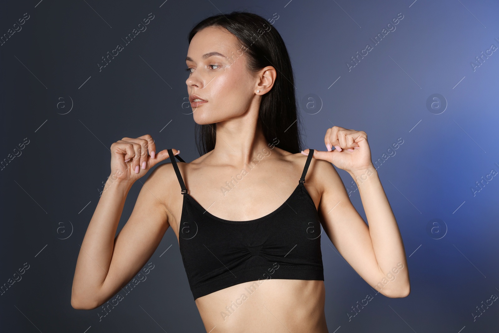 Portrait of beautiful young woman on dark background Photo of Portrait of beautiful young woman on dark background