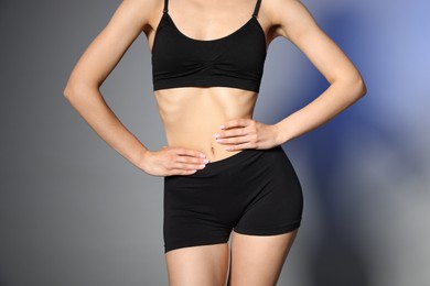 Photo of Woman with perfect slim body in studio, closeup
