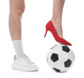 Photo of Woman in high heeled shoe and sneaker with soccer ball on white background, closeup
