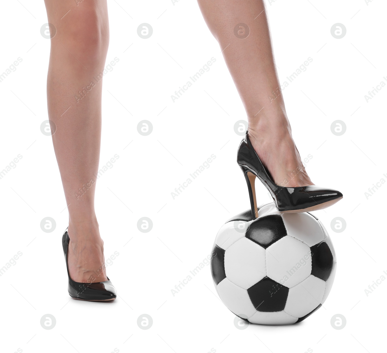 Photo of Woman in high heeled shoes with soccer ball on white background, closeup