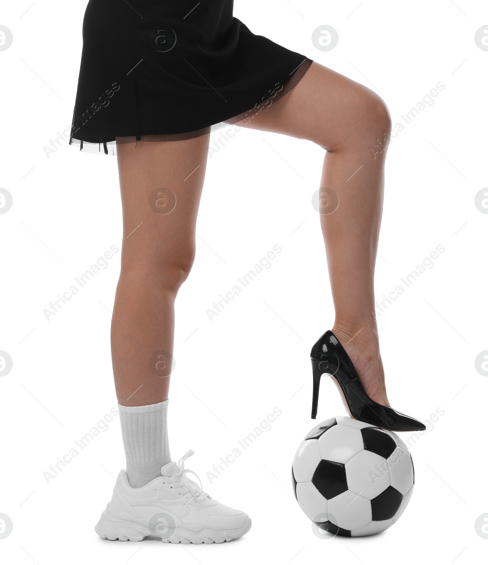 Photo of Woman in high heeled shoe and sneaker with soccer ball on white background, closeup