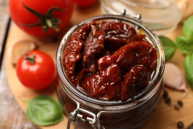 Photo of Tasty sun dried tomatoes, fresh vegetables and peppercorns on table, closeup