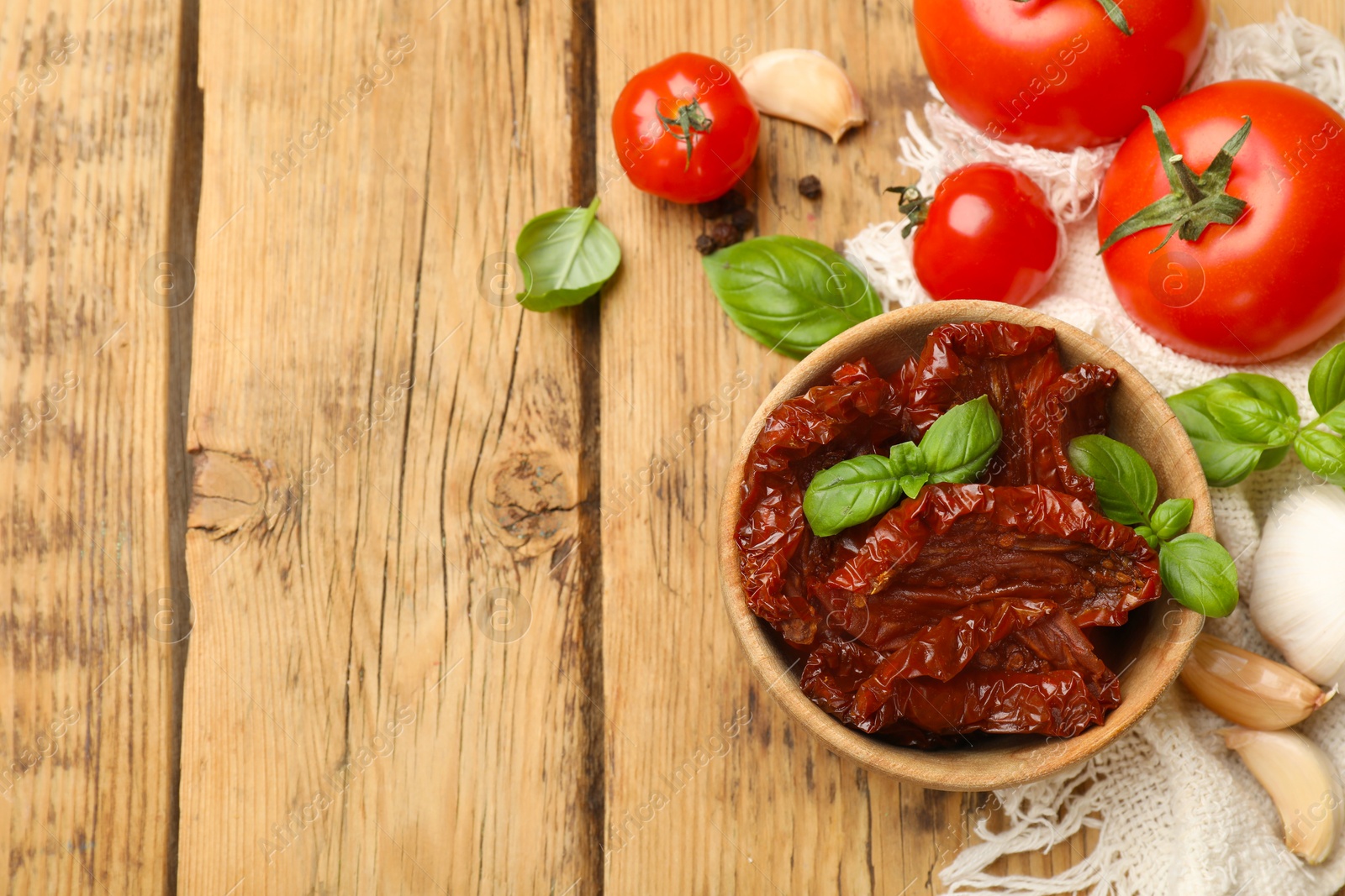 Tasty sun dried tomatoes, fresh vegetables and peppercorns on wooden table, flat lay. Space for text Photo of Tasty sun dried tomatoes, fresh vegetables and peppercorns on wooden table, flat lay. Space for text