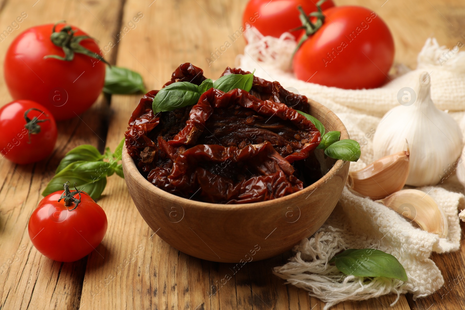 Tasty sun dried tomatoes and fresh vegetables on wooden table, closeup Photo of Tasty sun dried tomatoes and fresh vegetables on wooden table, closeup