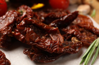 Photo of Tasty sun dried tomatoes and fresh vegetables on table, closeup