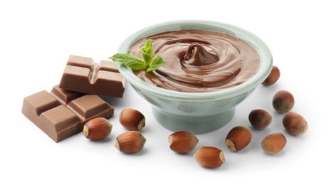 Photo of Tasty chocolate spread, pieces, mint and hazelnuts isolated on white