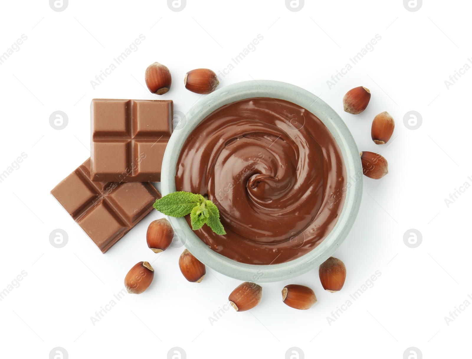 Tasty chocolate spread, pieces, mint and hazelnuts isolated on white, top view Photo of Tasty chocolate spread, pieces, mint and hazelnuts isolated on white, top view