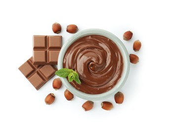 Photo of Tasty chocolate spread, pieces, mint and hazelnuts isolated on white, top view