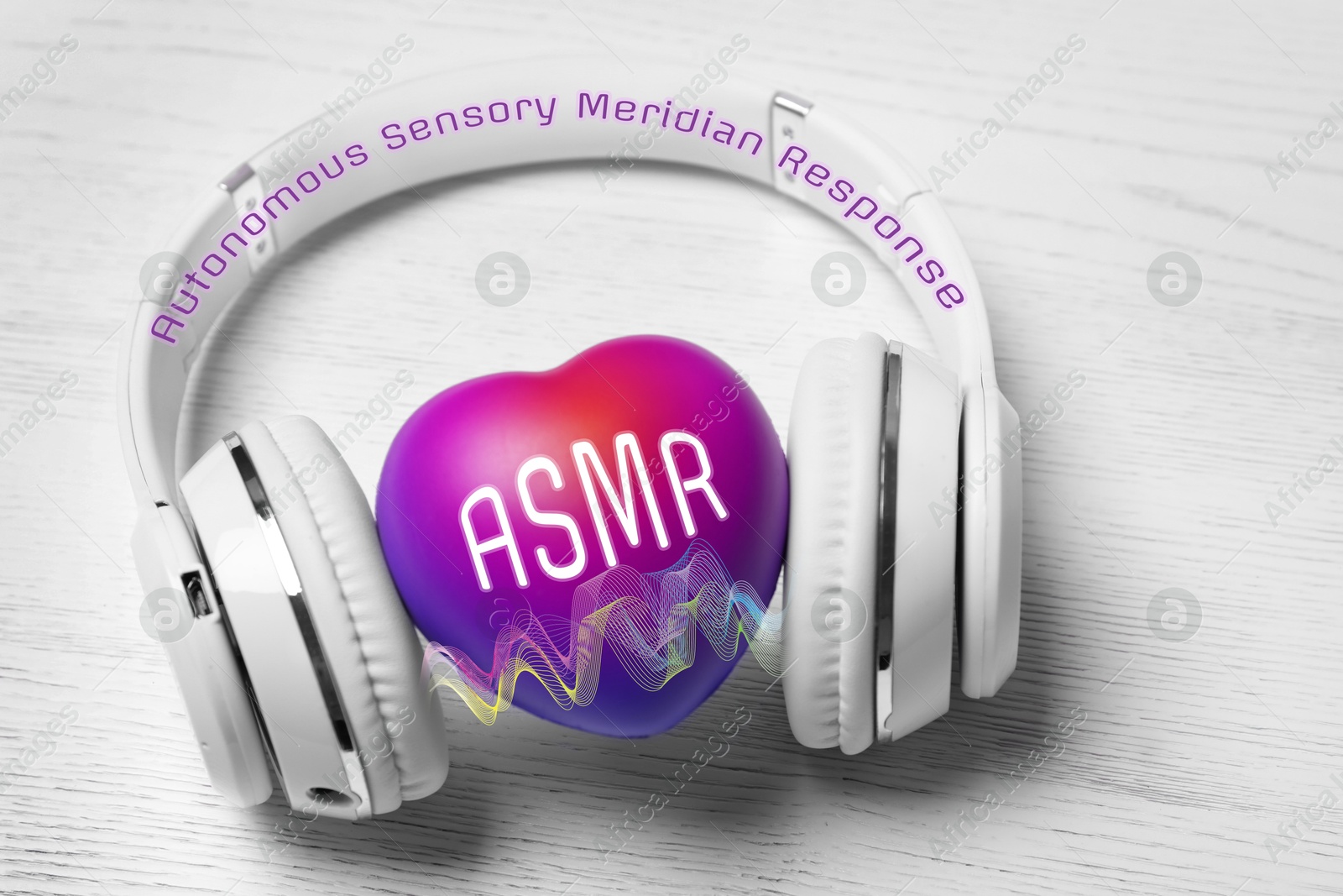 Autonomous sensory meridian response. Heart with ASMR abbreviation between headphones on white wooden table Image of Autonomous sensory meridian response. Heart with ASMR abbreviation between headphones on white wooden table