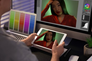 Image of Designer working on different devices at table in office. Man using tablet computer, closeup