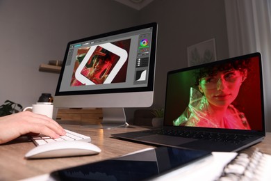 Image of Designer working on different computers at table in office, closeup