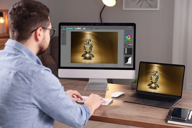 Image of Designer working on different computers at table in office