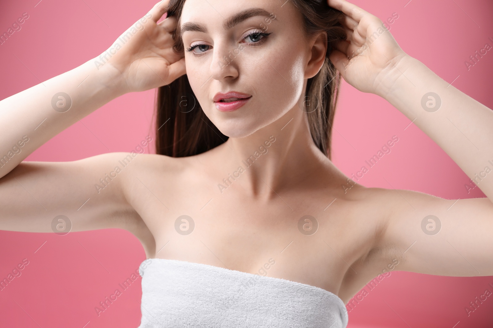 Portrait of beautiful woman on pink background Photo of Portrait of beautiful woman on pink background
