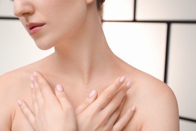 Photo of Woman with beautiful collarbones and neck on light background, closeup