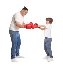 Photo of Father and his son boxing on white background
