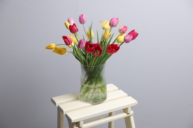 Photo of Bouquet of beautiful tulips on table indoors