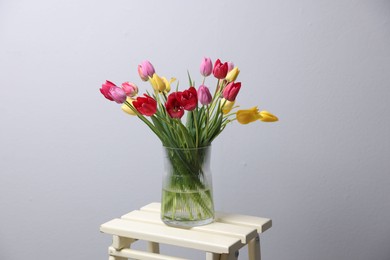 Photo of Bouquet of beautiful tulips on table indoors