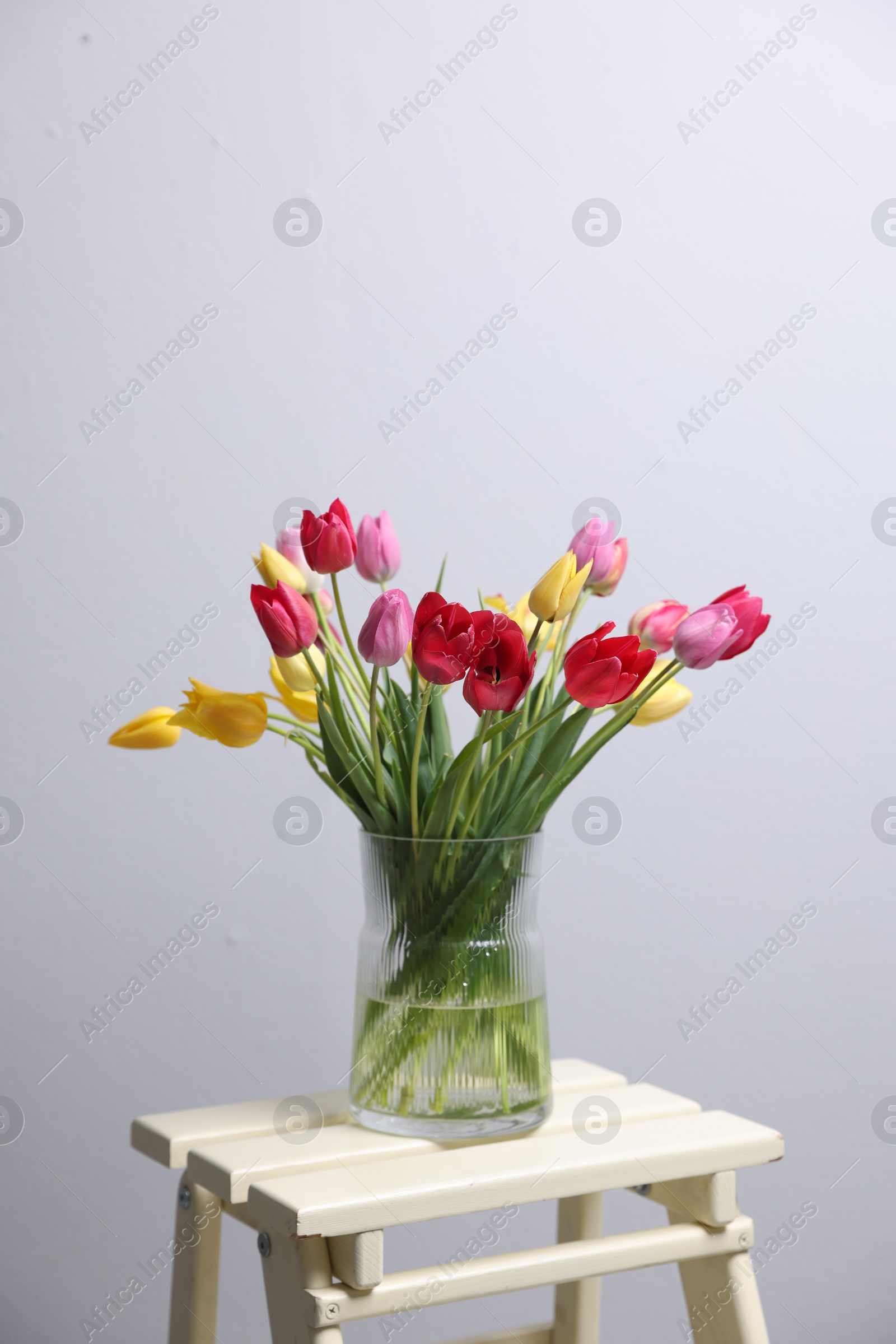 Photo of Bouquet of beautiful tulips on table indoors