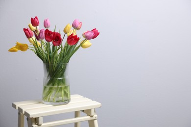 Photo of Bouquet of beautiful tulips on table indoors. Space for text