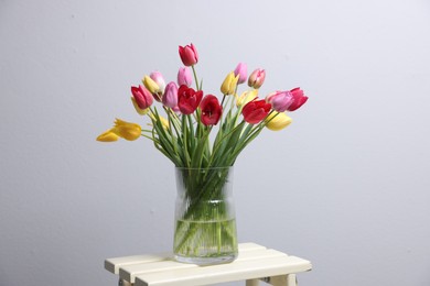 Photo of Bouquet of beautiful tulips on table indoors