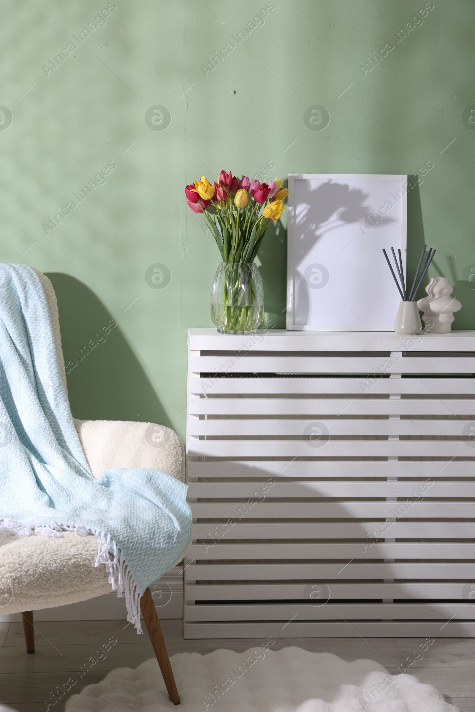 Photo of Bouquet of beautiful colorful tulips and decor indoors
