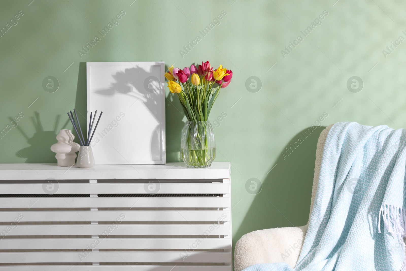 Photo of Bouquet of beautiful colorful tulips and decor indoors