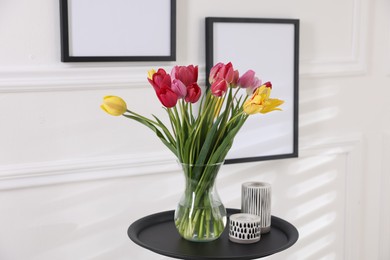 Photo of Bouquet of beautiful tulips and decor on table indoors