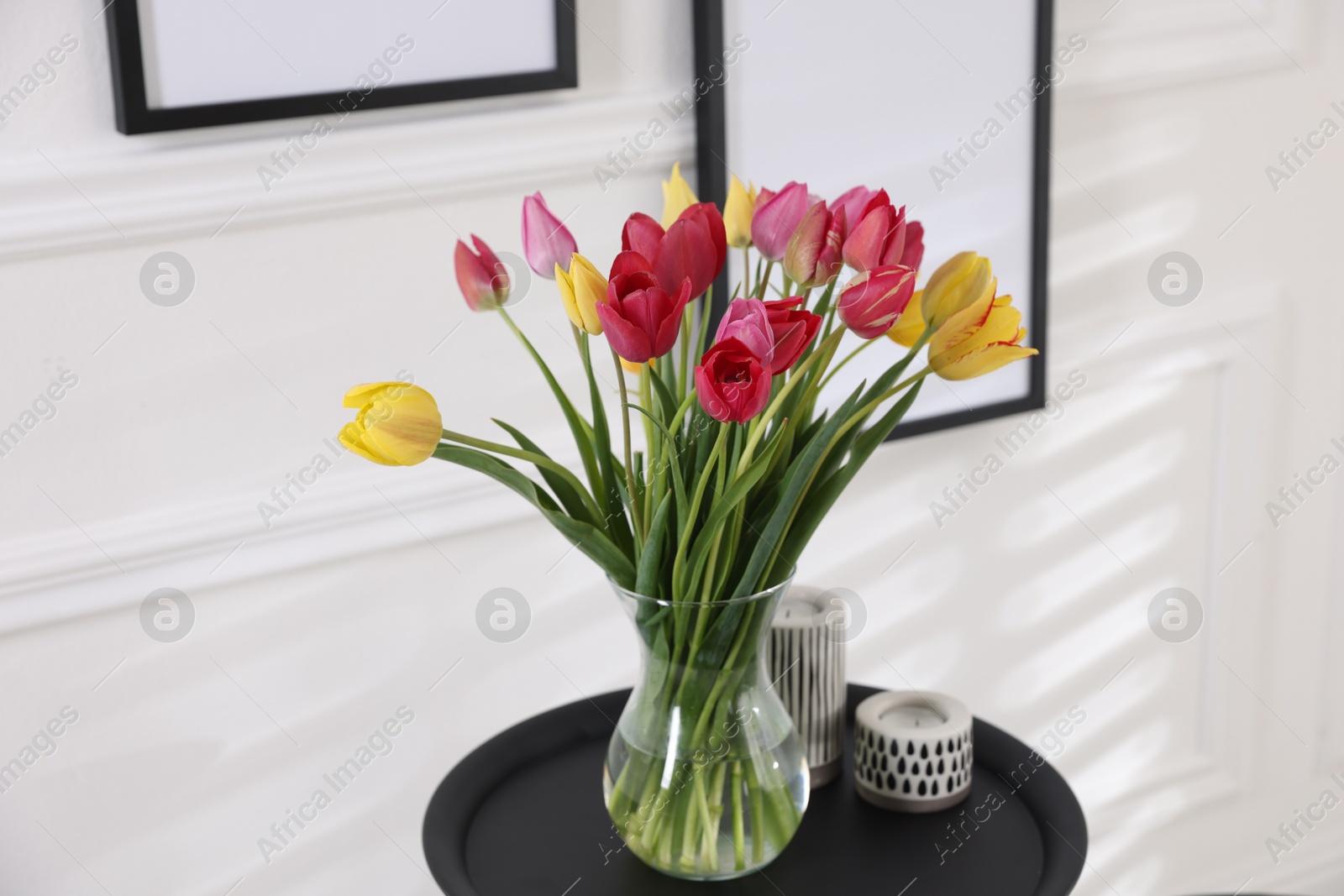Photo of Bouquet of beautiful tulips and decor on table indoors