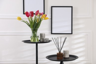 Photo of Bouquet of beautiful tulips and decor on tables indoors