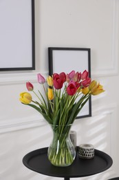 Photo of Bouquet of beautiful tulips and decor on table indoors