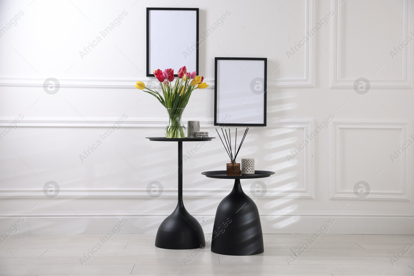 Photo of Bouquet of beautiful tulips and decor on tables indoors