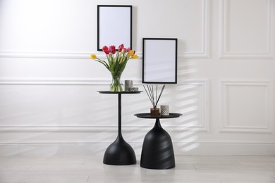 Photo of Bouquet of beautiful tulips and decor on tables indoors